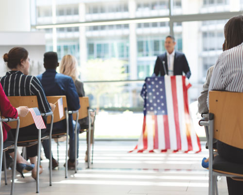 speaker at flag podium